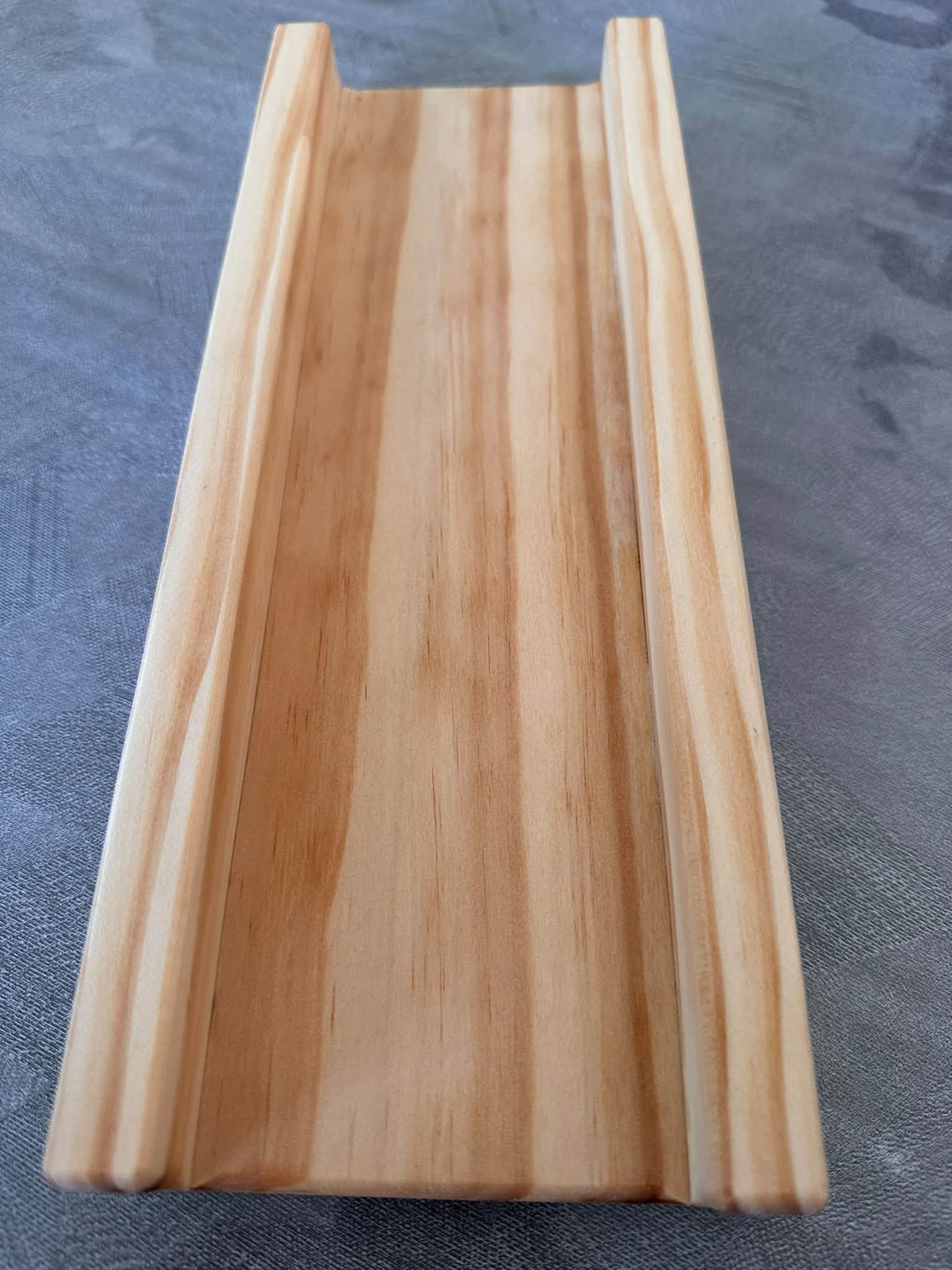 Lengthwise view of the SpringRollPro guide showing the natural timber grain