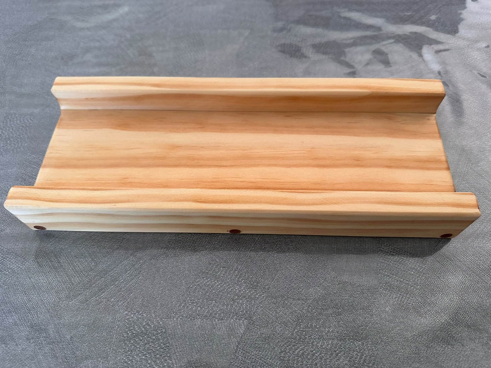 SpringRollPro wooden guide viewed from the side, with both raised rails visible